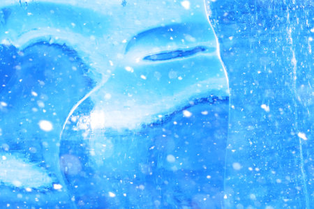 Texture of ice in winter. Pieces of frozen water on a street in the winter. The texture and texture of the frozen water in winter and outdoor.の写真素材