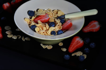 Ready breakfast corn flakes with fresh berriesの写真素材