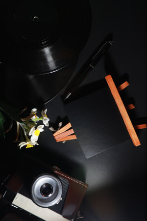 Vinyl plate and retro camera on the tableの写真素材