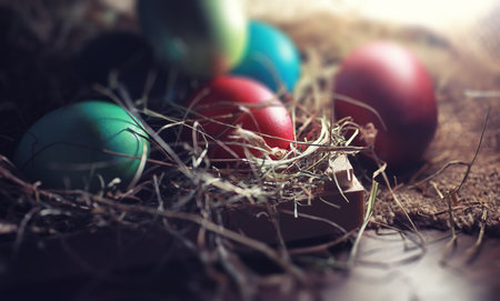 Easter painted eggs on burlap and strawの写真素材