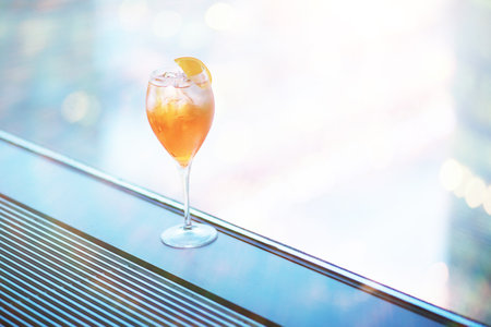 Cocktail glasses on the windowsill by the glass of a tall buildingの写真素材