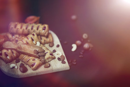 Set for breakfast. Sweets and pastries with nuts for tea on black background. A coffee cup and patties.の写真素材