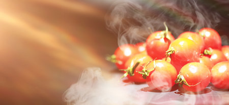Cherry tomatoes on black background in the sprayの写真素材