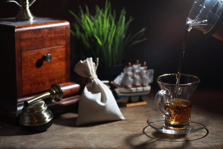 Brewing tea on a wooden table in the morning
