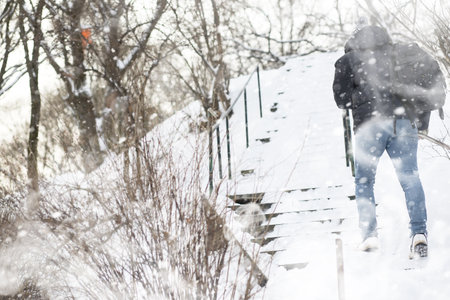 A man walks through the city on a snowy winter day.の写真素材