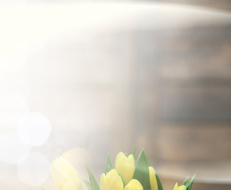 bouquet of yellow tulips in a vase on floorの写真素材