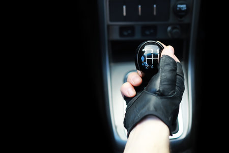 Gear lever. Manual Transmission. Hand on the gear shift in the car.