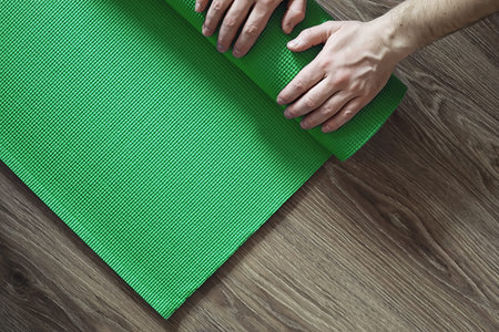 Mat for practicing yoga on a floor. Healthy lifestyle.