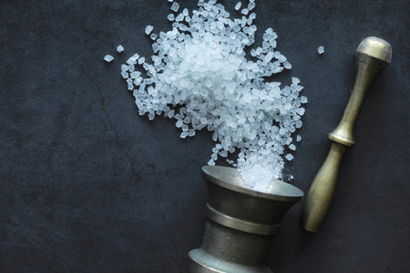 Large sea salt. Spice. Mortar and pestle for grinding salt.の写真素材