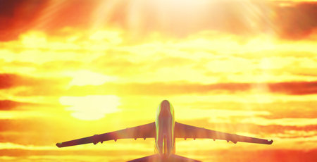 The travel by plane flies in the sky above the clouds.の写真素材