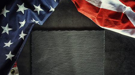 American flag on a black stone background. Space for text.