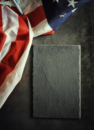 American flag on a black stone background. Space for text.の写真素材