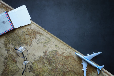 Travel concept. Map on the table and model aircraft.の写真素材