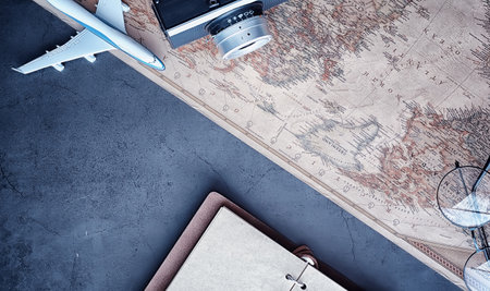 Travel concept. Map on the table and model aircraft.の写真素材