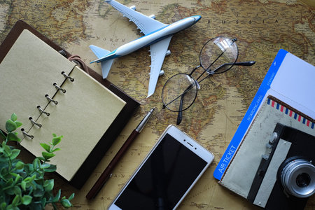 Travel concept. Map on the table and model aircraft.の写真素材