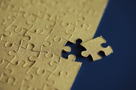 Clean puzzle elements on the background. Empty puzzle piece on table. Teamwork concept.