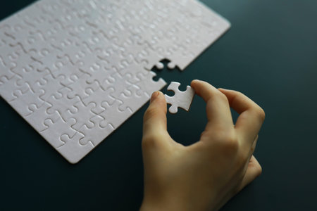 Intellectual puzzles. The puzzle empty. The hand puts together puzzle pieces. Brain training.