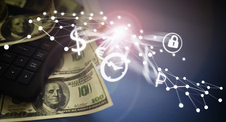 Computer keyboard and a scattering of 100 dollar bills on the table. The work of a programmer and...