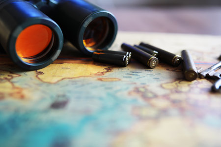 Binoculars and reflection in lenses. Map background.の写真素材