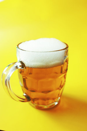 Saint Patrick's Day holiday. National Irish holiday. Green beer Hand with a mug emerald beer in a bar.の写真素材