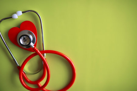 Doctor at his desk in the clinic's office. Stethoscope, test tubes, laptop, prescriptions, glasses on table.の写真素材