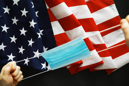 American health care system. USA flag background. Medical mask and stethoscope.の写真素材