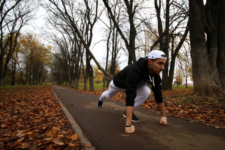 Young man in an autumn parkの写真素材
