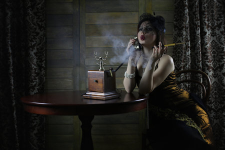 Beautiful 1930s girl at the tableの写真素材