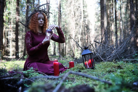 Witch holds a ritual in the depths of the forestの写真素材