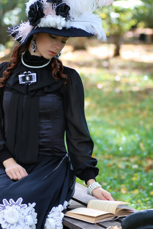 girl in retro dress past century read letter on the benchの写真素材