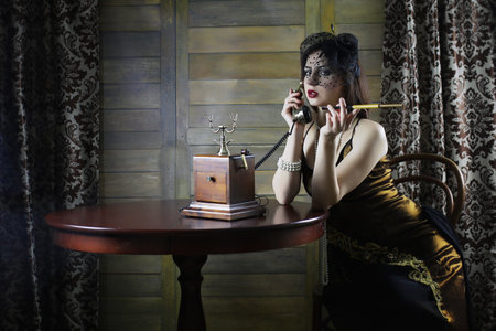 Beautiful 1930s girl at the tableの写真素材