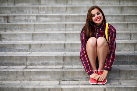 Cute girl in a clown makeup on a background of a fair and stepsの写真素材