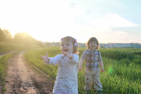 Children outdoors on nature in the grass fieldの写真素材