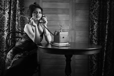 Beautiful 1930s girl at the tableの写真素材