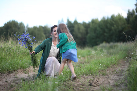 Beautiful young mother with daughter walkingの写真素材
