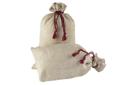 Two decorative bags tied with a lace of rough fabric isolated on a white background.の写真素材