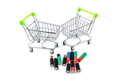 Old batteries and empty trolleys, collection and recycling of spent batteries and batteries on whiteの写真素材