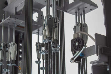 Elements of fastening steel cables in the glass shaft of the elevator.