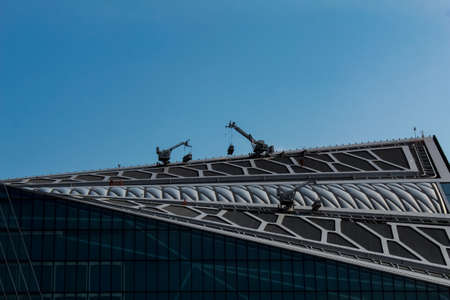 Maintenance and construction work on the roof of the office building.の写真素材