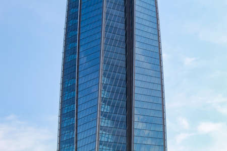 Fragment of the facade of the office building against the blue sky.の写真素材
