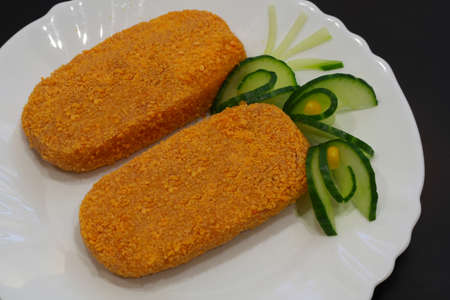 Meat semi-finished, meatballs in breadcrumbs on a white plate.の写真素材