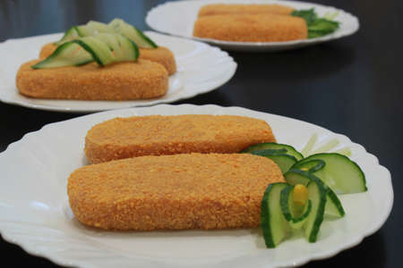 Meat semi-finished, meatballs in breadcrumbs on a white plate.の写真素材