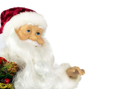 Santa Claus in a red suit and a large bag of gifts on a white background, the view from the side.の写真素材