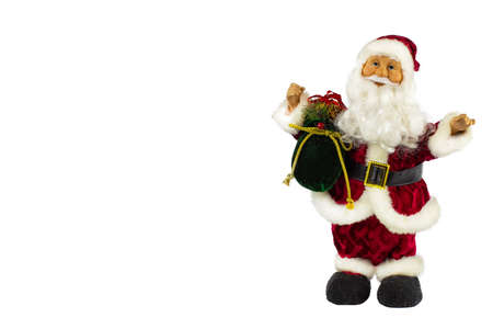 Santa Claus in a red suit and a large bag of gifts on a white background, the view from the side.の写真素材