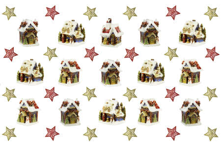 Christmas card made of figures of snow-covered houses and colorful stars on a white background.の写真素材