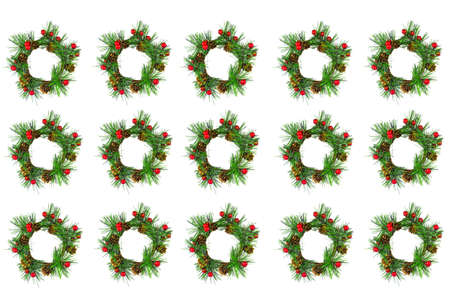 Wreath of spruce branches decorated with small red balls isolate on white.の写真素材