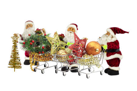 Three Santa Claus with baskets full of Christmas decorations and gifts on a white background.の写真素材