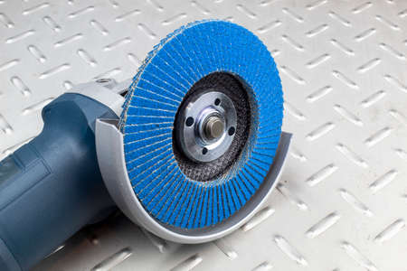 Fragment of an electric grinding machine, with a zirconium disk for metal processing.の写真素材