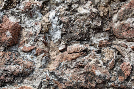 Fragment of the wall of the old house, stone masonry made of natural granite.の写真素材