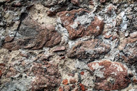 Fragment of the wall of the old house, stone masonry made of natural granite.の写真素材